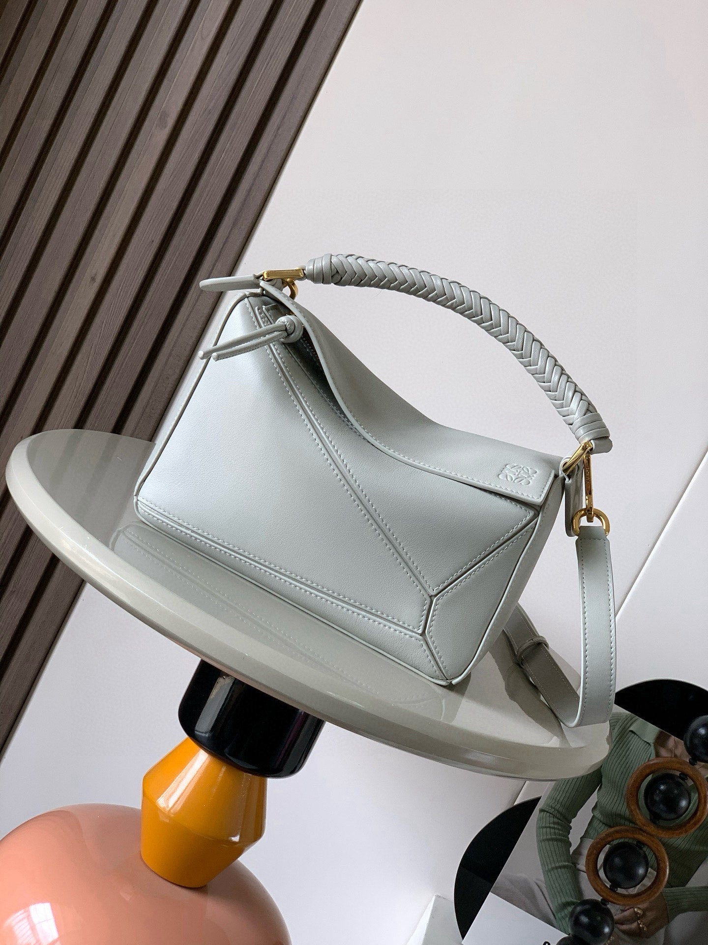 Loewe light blue mini shoulder bag with braided top handle and side strap.