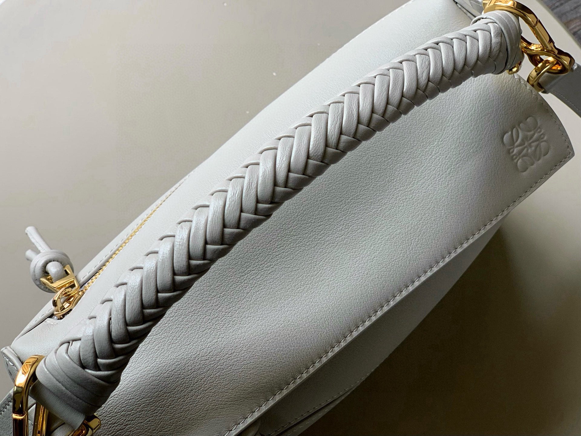 Loewe light blue woven strap detail and top zipper with gold hardware.