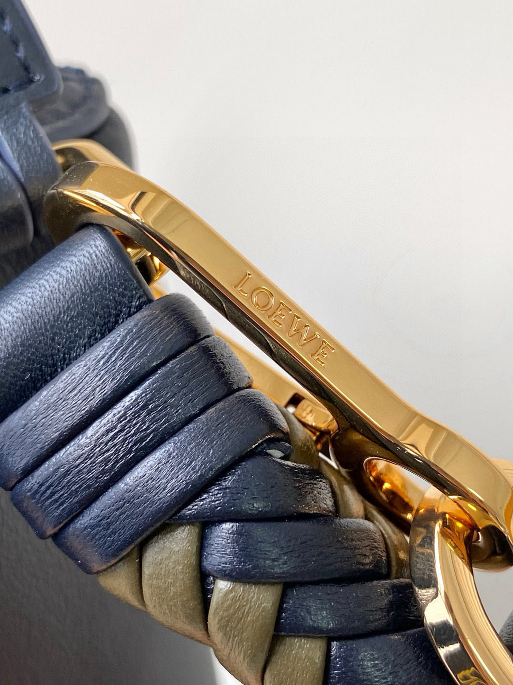Blue leather bag with gold Loewe logo bar and braided strap hardware