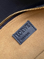 Blue leather bag lining label with Loewe logo on tan panel