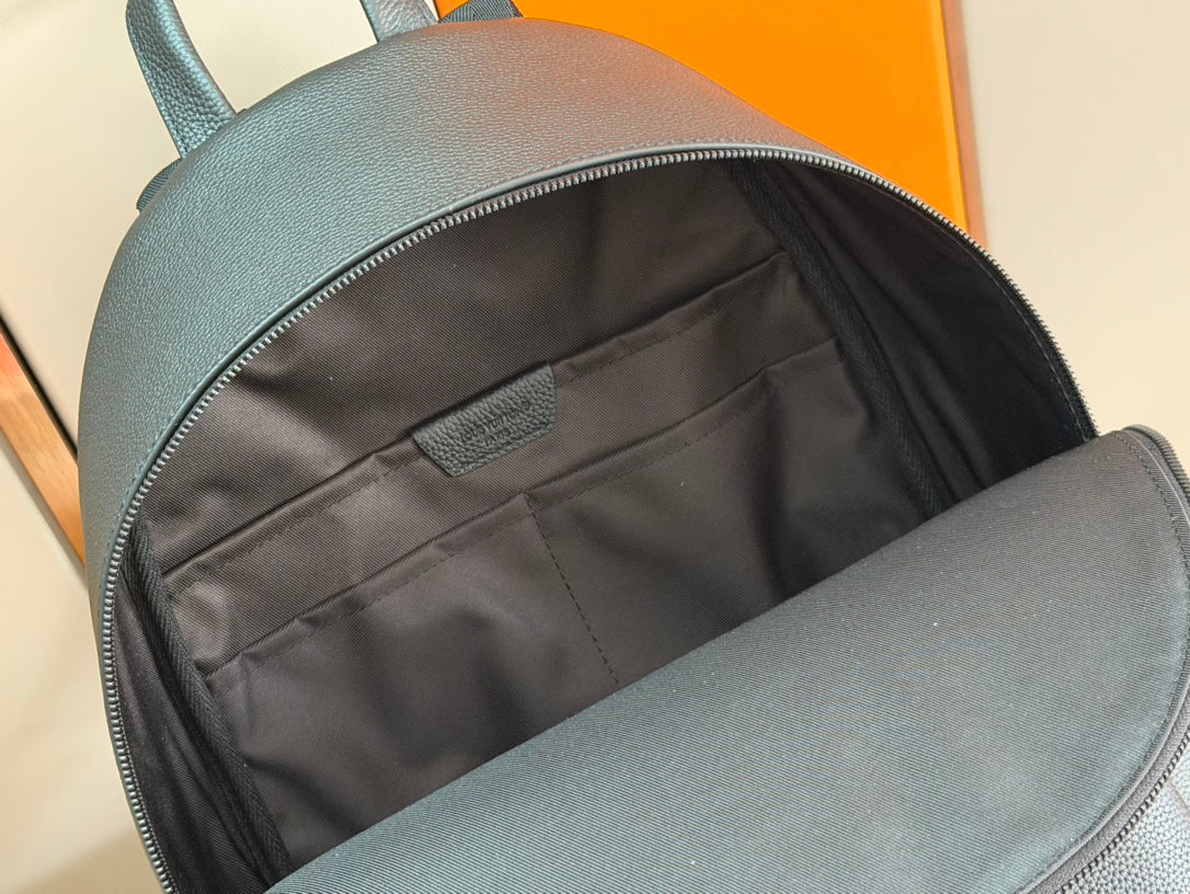 Leather backpack interior with black lining and zip opening, dark teal