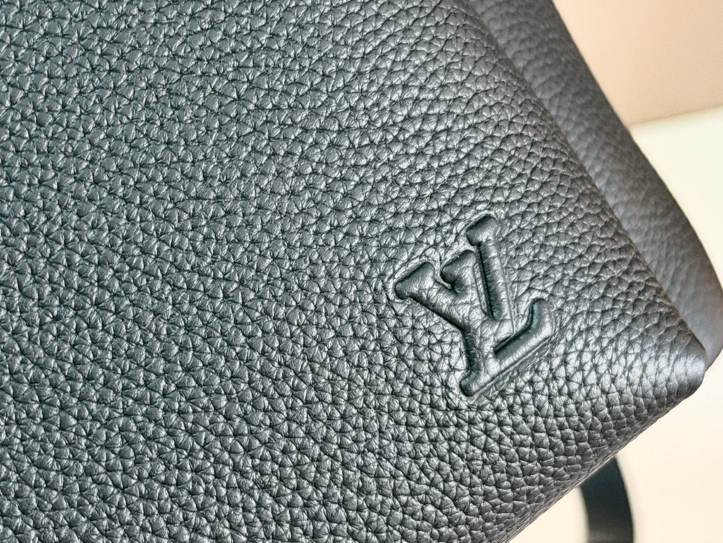 Louis Vuitton embossed logo on textured leather panel, dark teal
