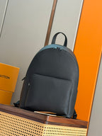 Louis Vuitton leather backpack with top handle and front zipper pocket, dark teal