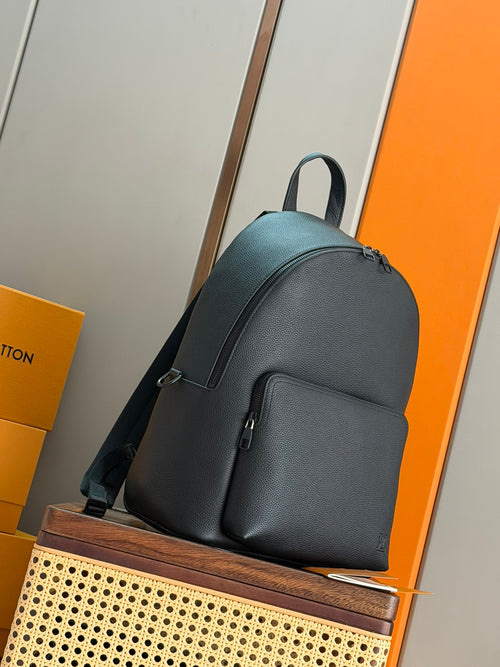 Louis Vuitton leather backpack with adjustable shoulder strap and front pocket, dark teal