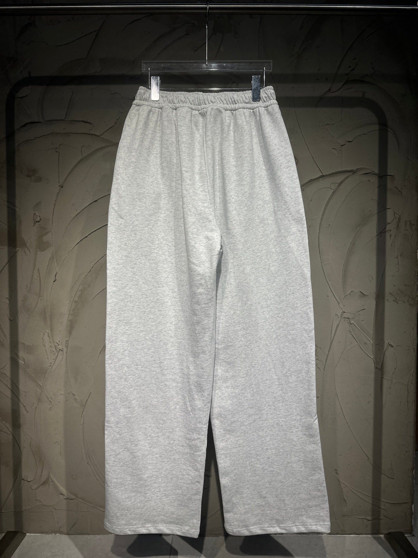 Heather-gray sweatpants with elastic waistband, drawstring, and roomy straight legs.