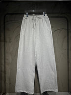 Heather-gray sweatpants with elastic waistband, drawstring, and wide straight legs.