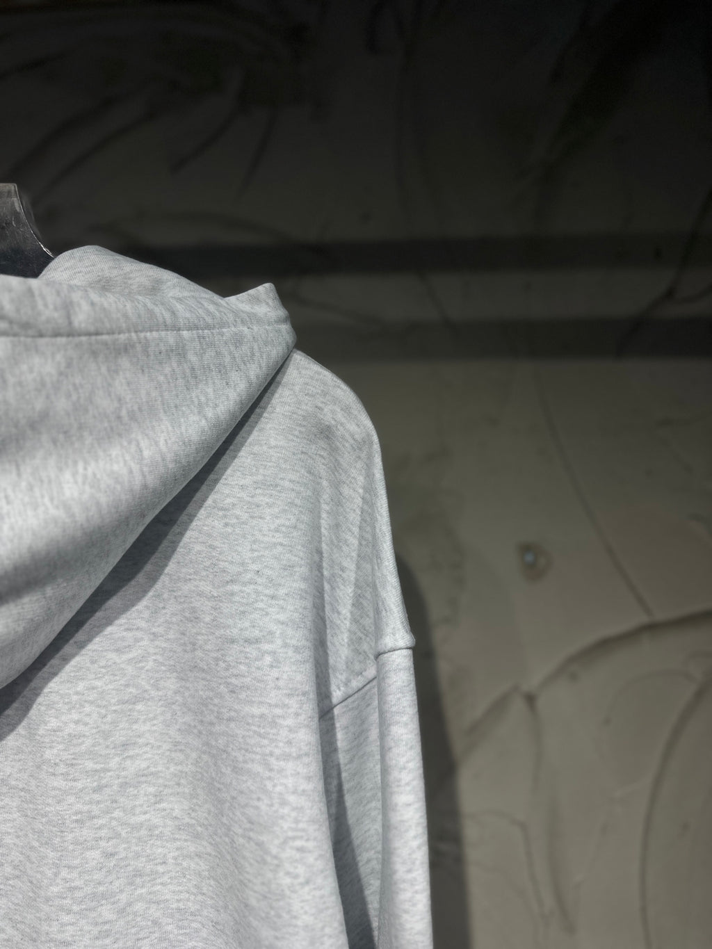 Light gray long-sleeve hoodie with hood and draped neckline