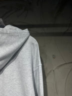 Light gray long-sleeve hoodie with hood and draped neckline