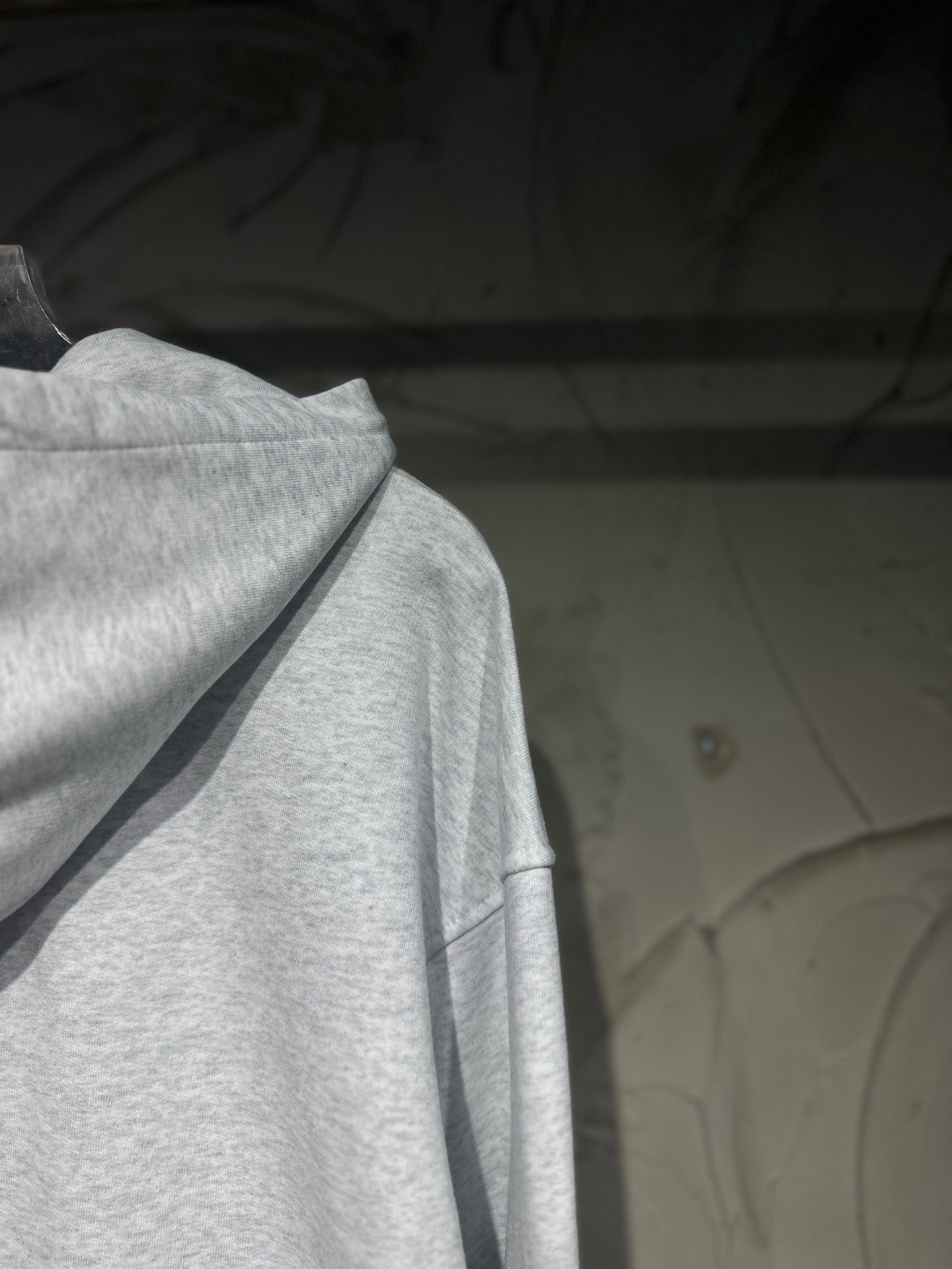 Light gray long-sleeve hoodie with hood and draped neckline