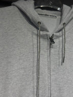 Light gray hoodie with front zipper and metallic chain drawstrings at hood