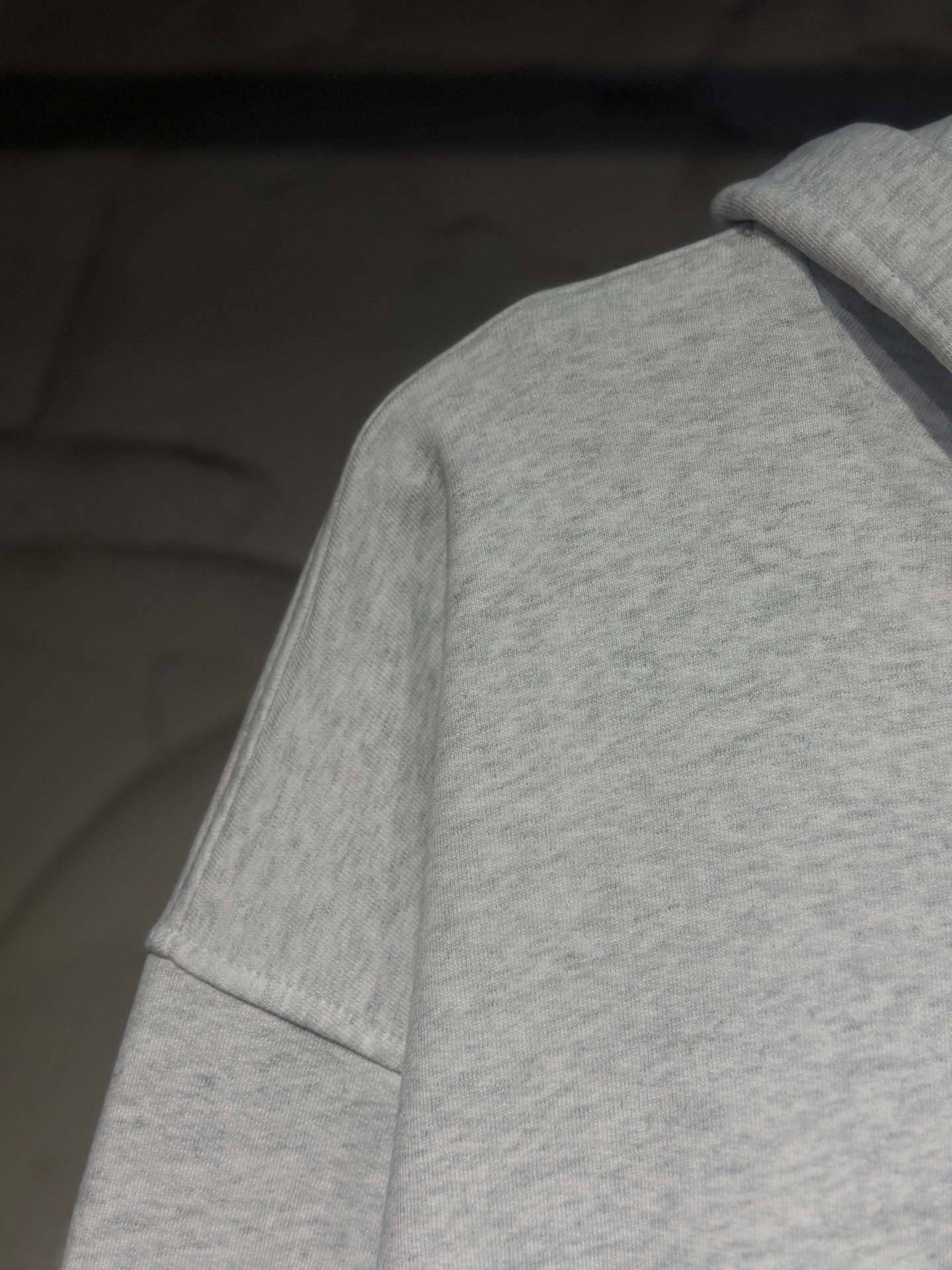 Light gray hoodie sleeve and shoulder with cuff seam detail
