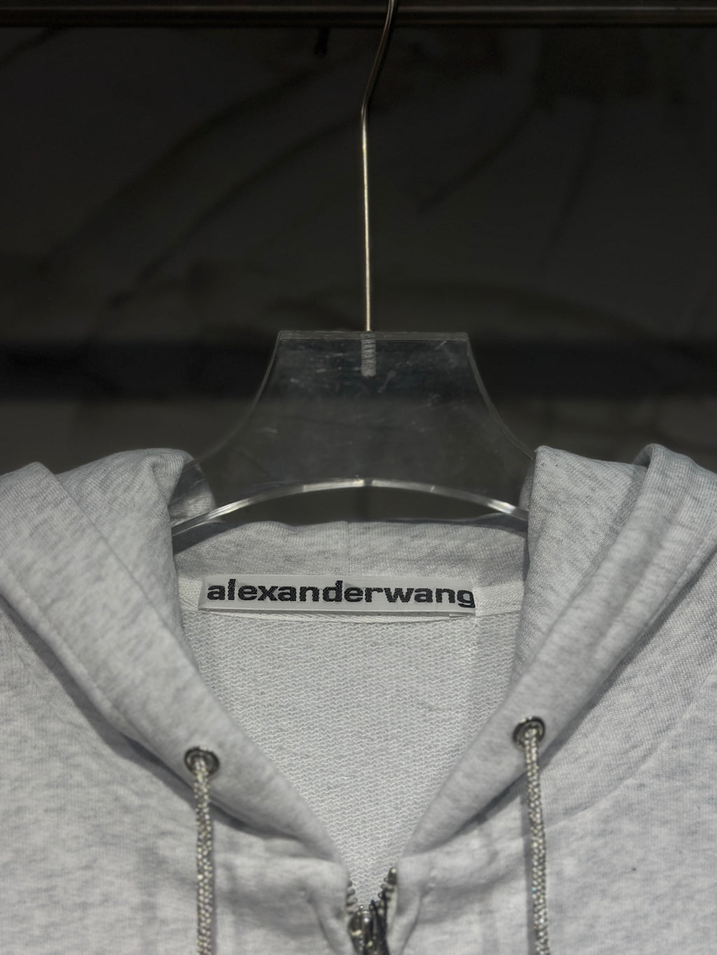 Light gray hoodie neckline with alexanderwang logo label and drawstring hood