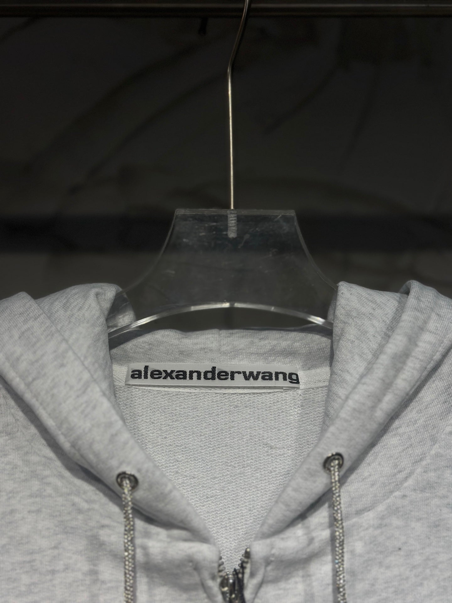 Light gray hoodie neckline with alexanderwang logo label and drawstring hood