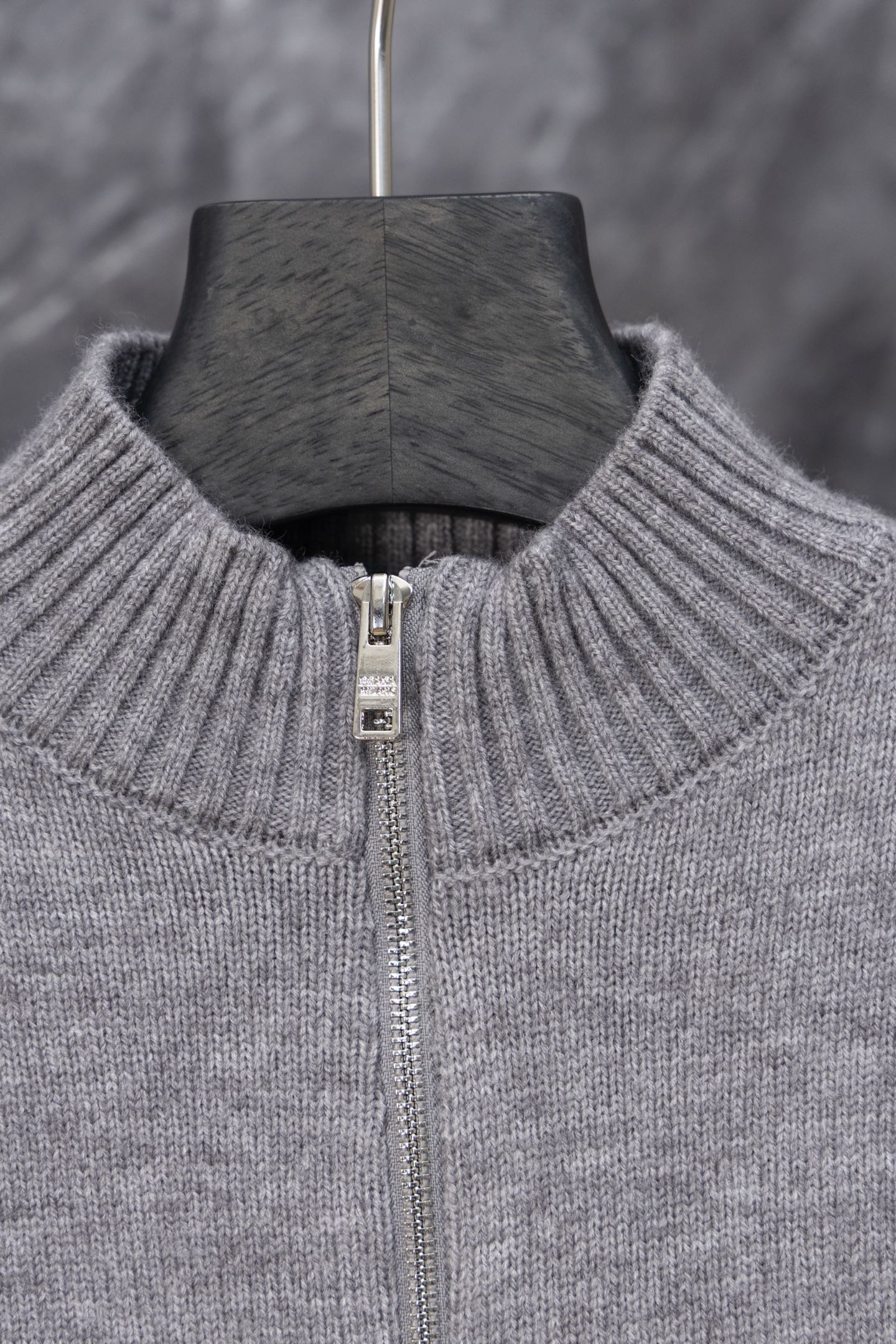 Gray Prada knit sweater neckline close-up with full-length zipper and ribbed collar