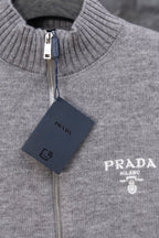 Gray Prada knit zip sweater close-up of ribbed stand collar, PRADA logo and tag