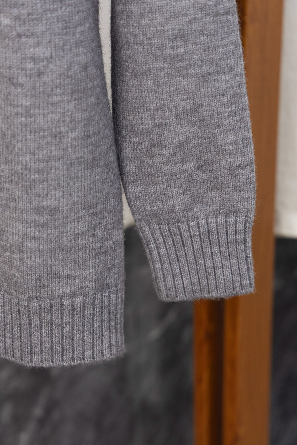 Gray Prada knit sweater sleeve and ribbed cuff, side view