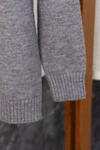 Gray Prada knit sweater sleeve and ribbed cuff, side view