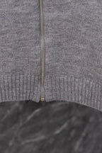 Gray Prada knit zip sweater center close-up with zipper and ribbed hem