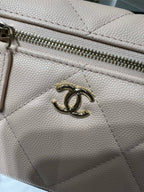 Cream leather zipper pull detail with gold-toned Chanel CC hardware