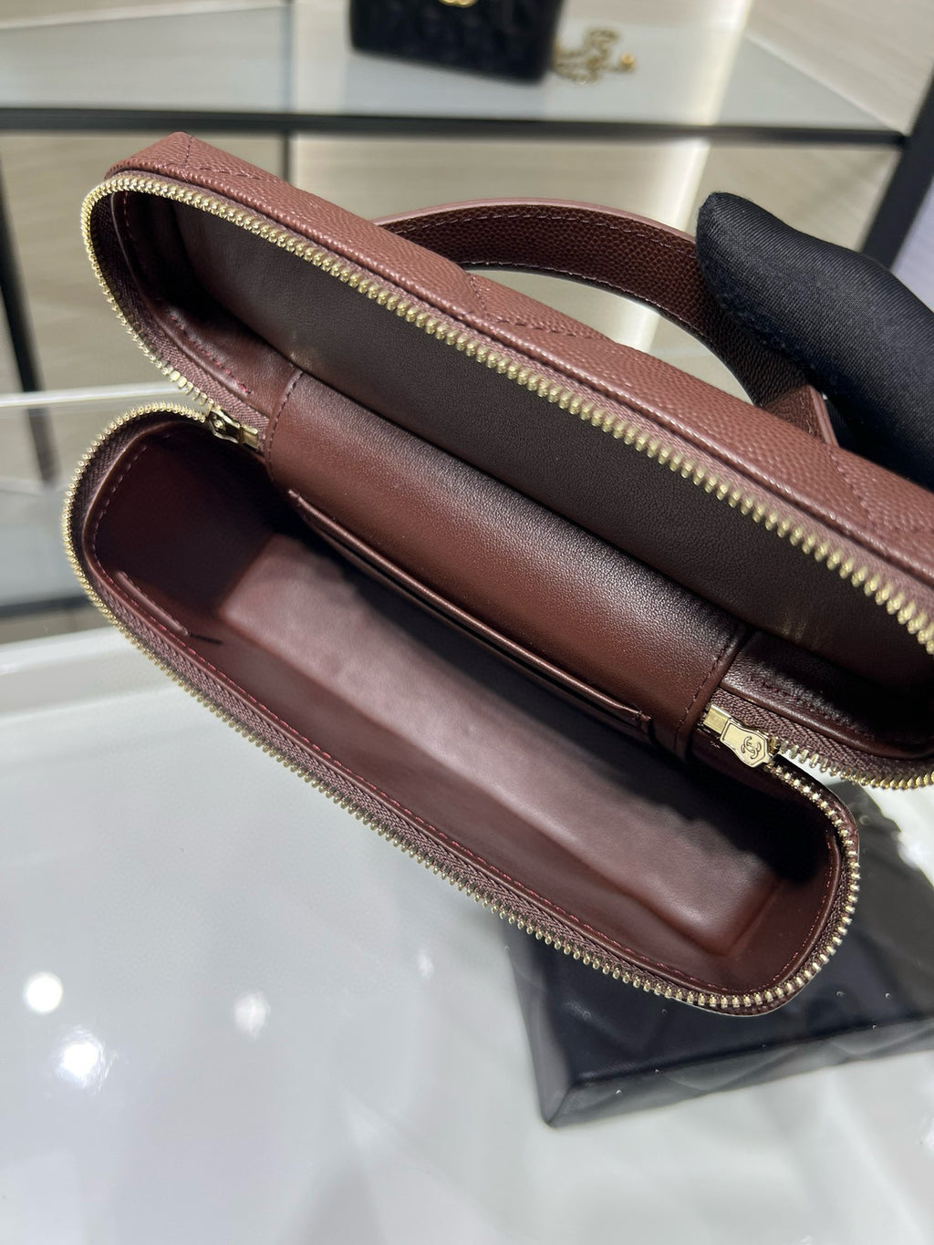 Chanel burgundy mini bag open view showing interior and zippered pocket