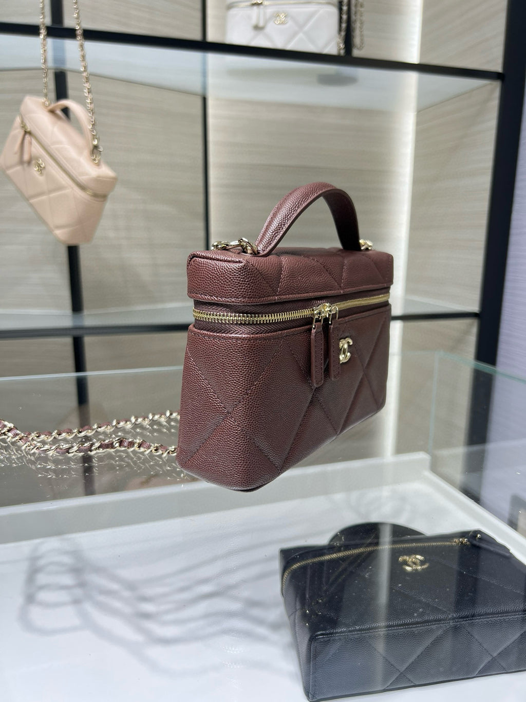 Chanel burgundy mini satchel bag with quilted texture, top handle, and chain strap