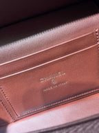 Chanel burgundy leather interior stamp reading “CHANEL”