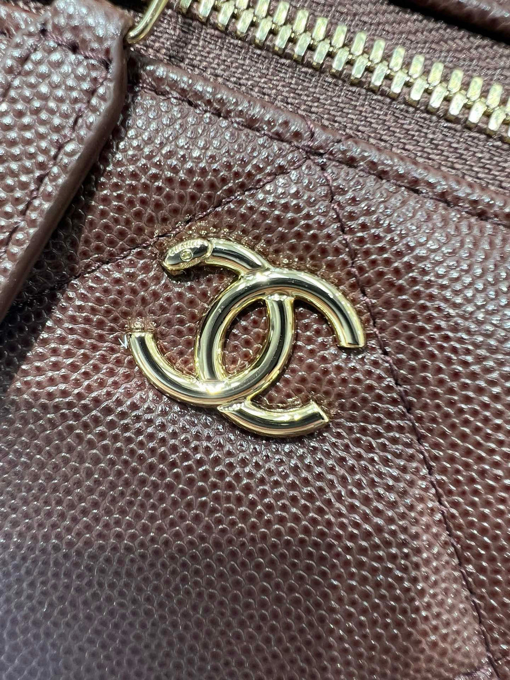 Chanel burgundy textured leather with gold-tone CC logo on front