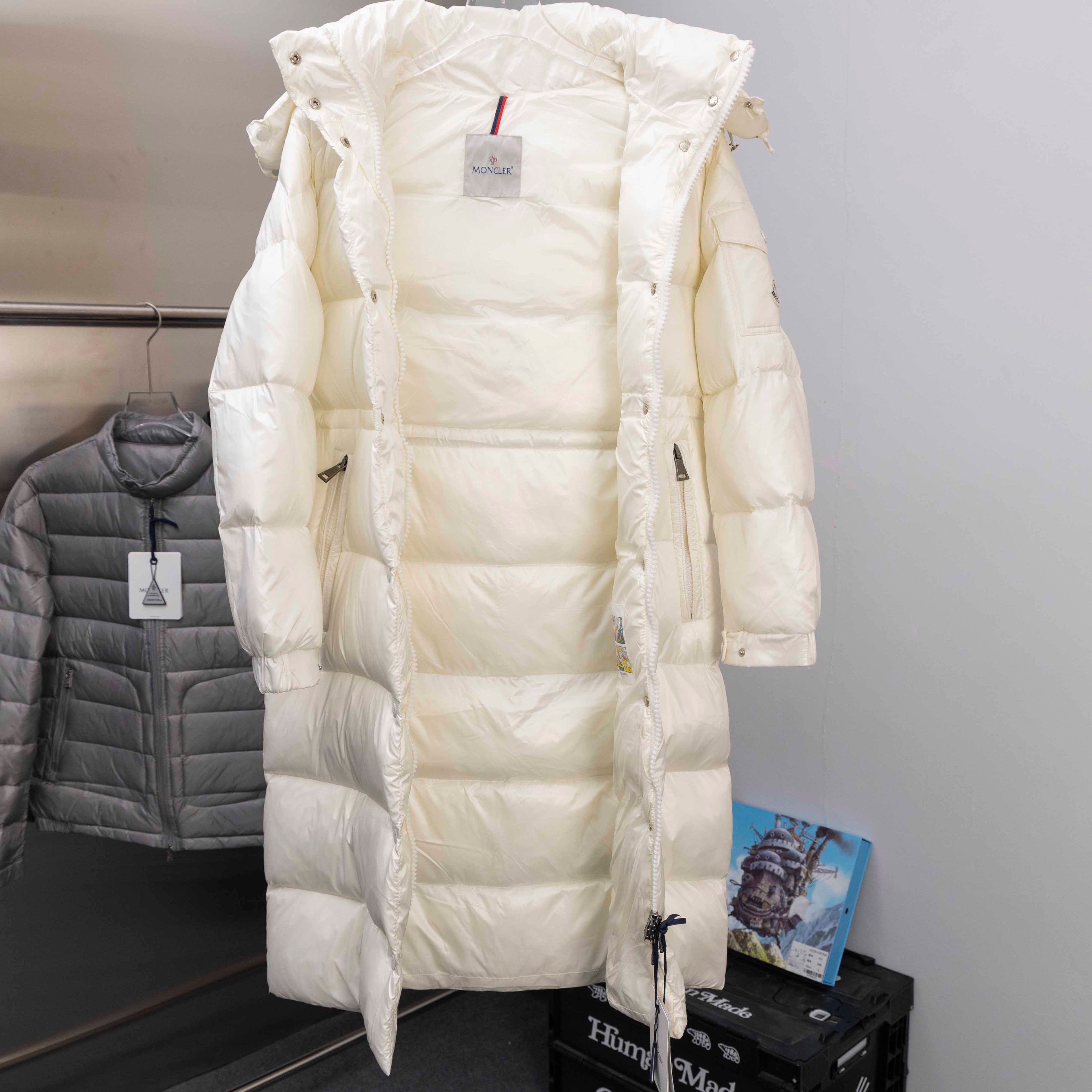 White long puffer jacket with hood and full-length quilted construction, front view