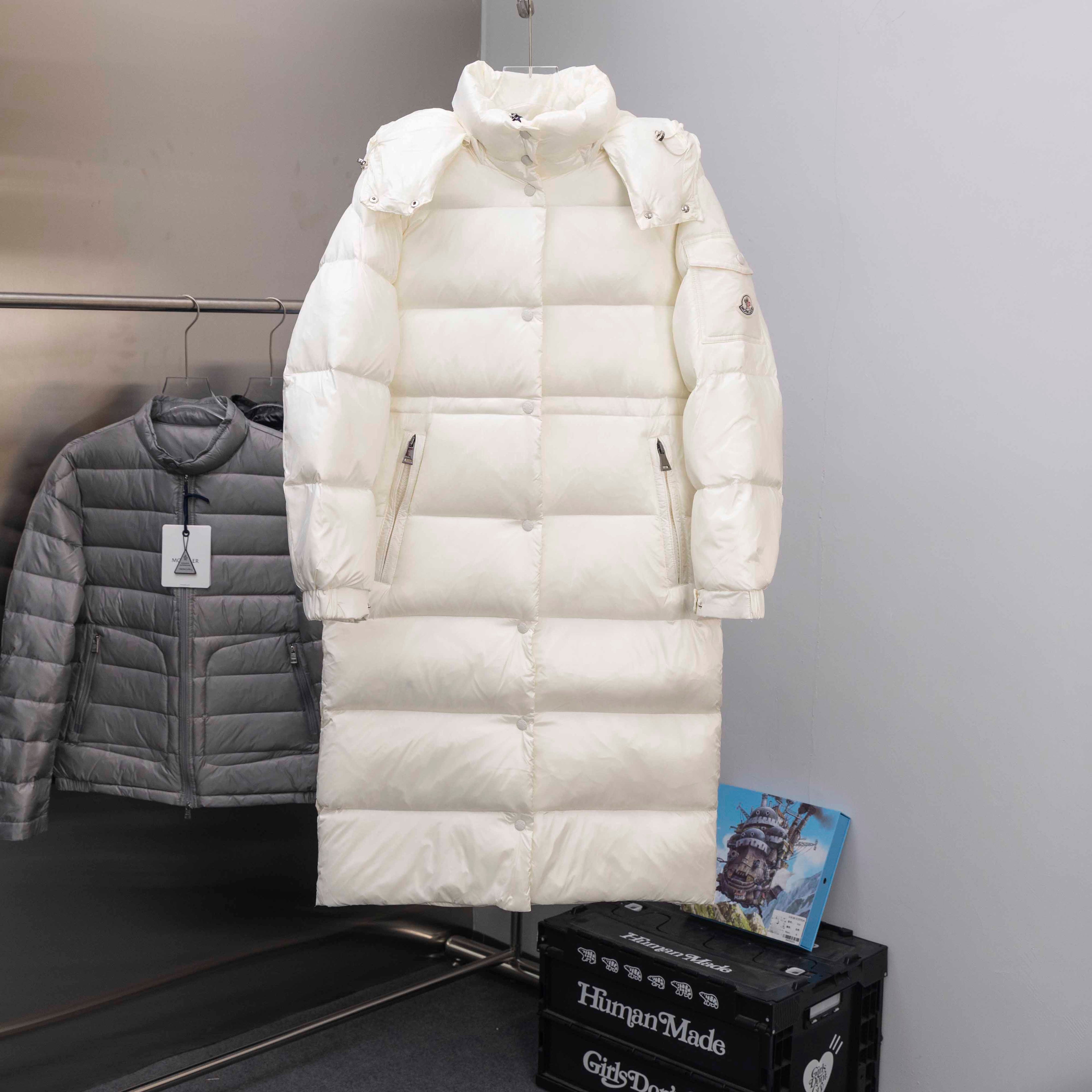 Long white puffer jacket with hood and zip front, snap details and side pockets
