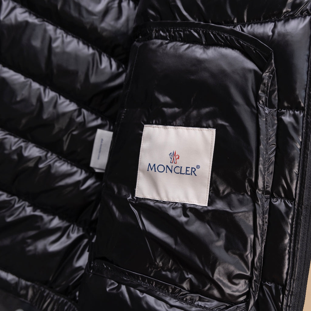 Black puffer jacket fabric label on quilted lining under front flap