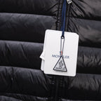 Black puffer jacket with hanging Moncler tag on blue zipper pull