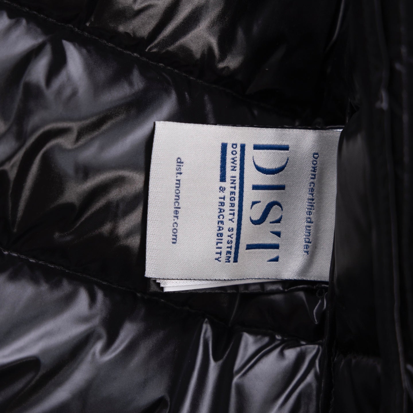 Black puffer jacket fabric label on quilted interior panel