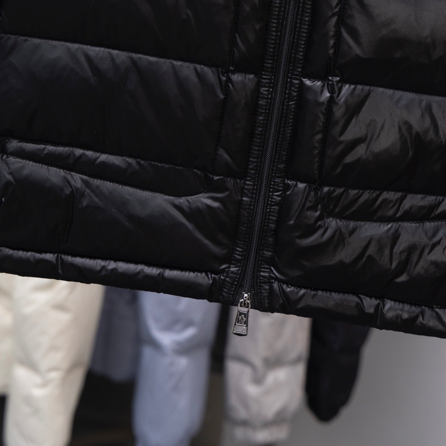 Moncler long puffer jacket, dark quilted fabric with front zipper and padded panels