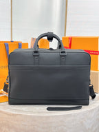 Louis Vuitton bag front view in dark gray leather with zipper closure and shoulder strap.