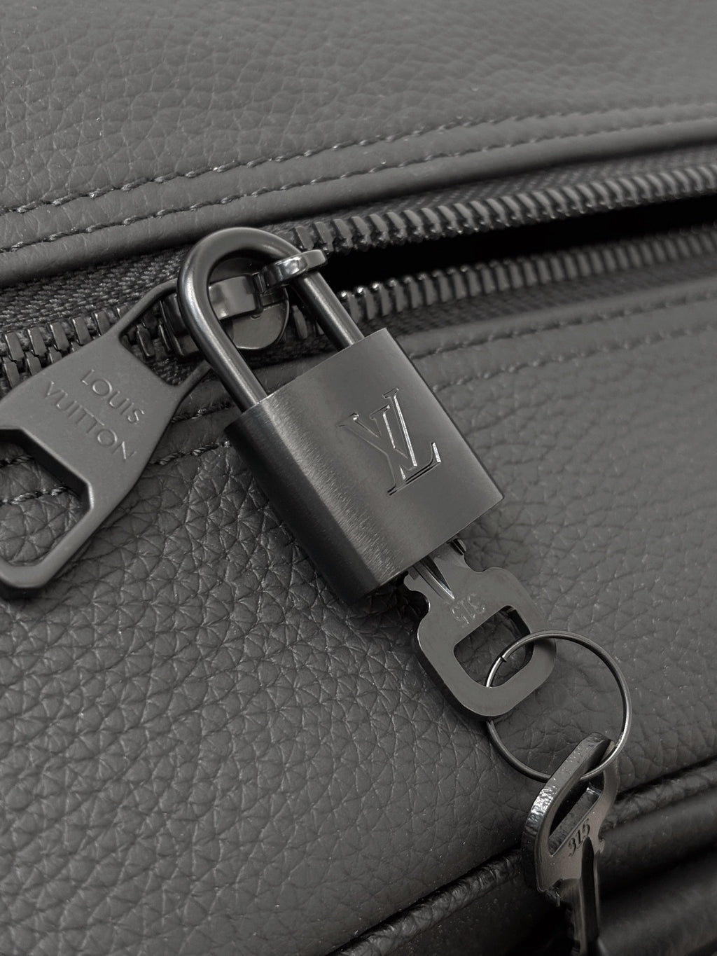 Dark gray leather zipper pull with lock charm and metal ring