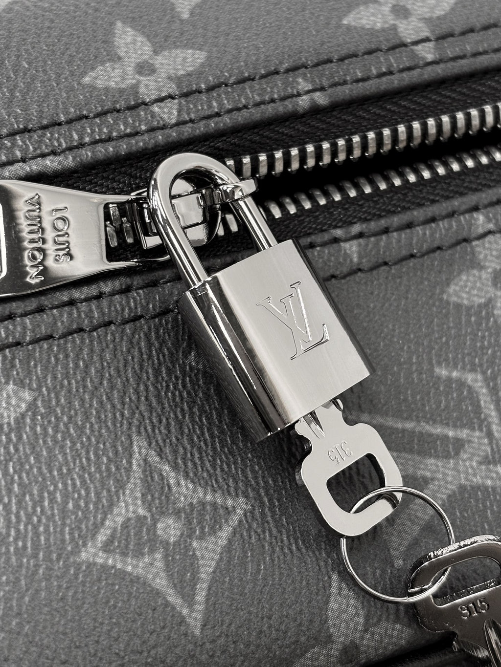Louis Vuitton monogram bag close-up: silver zipper pull and lock hardware