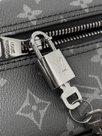 Louis Vuitton monogram bag close-up: silver zipper pull and lock hardware