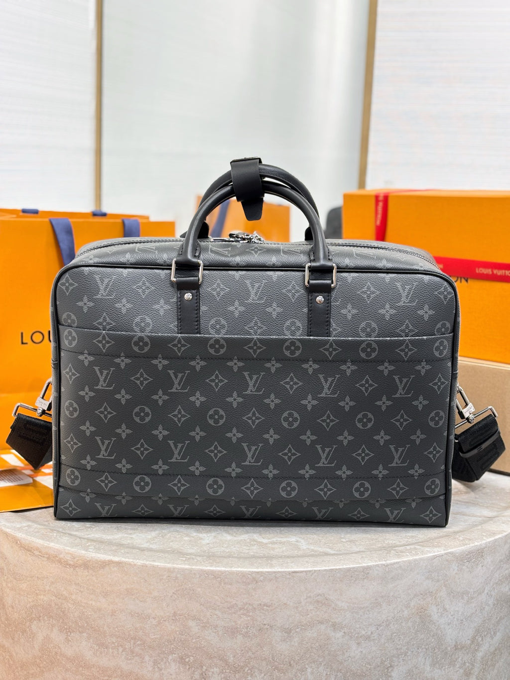 Men's Louis Vuitton patterned briefcase with top handles and adjustable shoulder strap