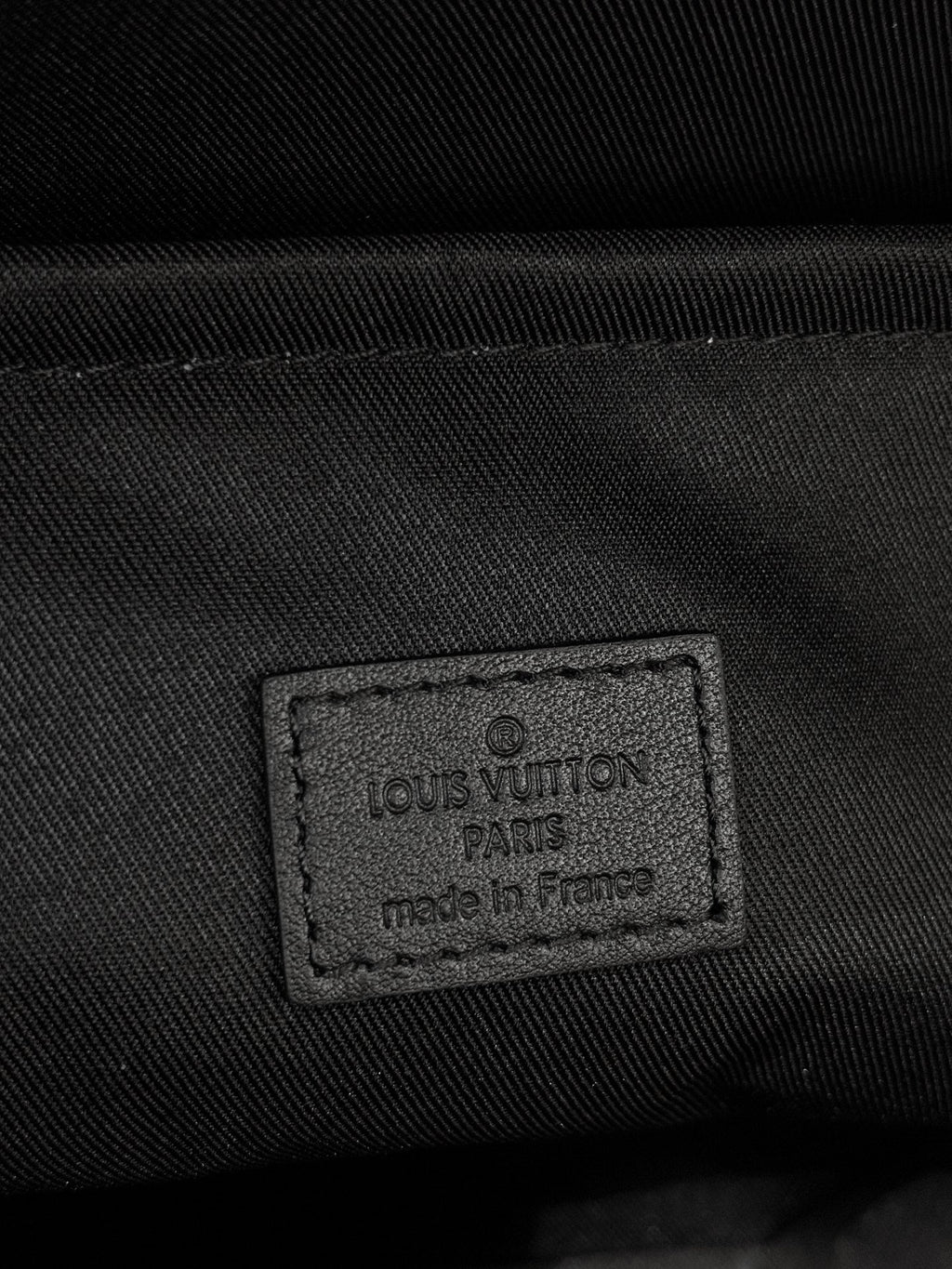 Louis Vuitton bag fabric label patch on black interior lining