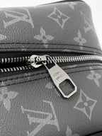 Louis Vuitton bag close-up of dark monogram canvas zipper with engraved pull tab