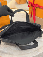 Louis Vuitton men’s leather tote bag, black, open top showing interior lining
