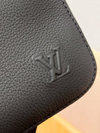 Louis Vuitton black leather corner with embossed LV logo