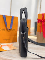 Louis Vuitton black leather handbag side profile with zip pocket and strap