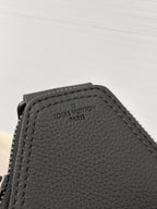 Black leather bag interior patch with 'Louis Vuitton Paris' stamp.