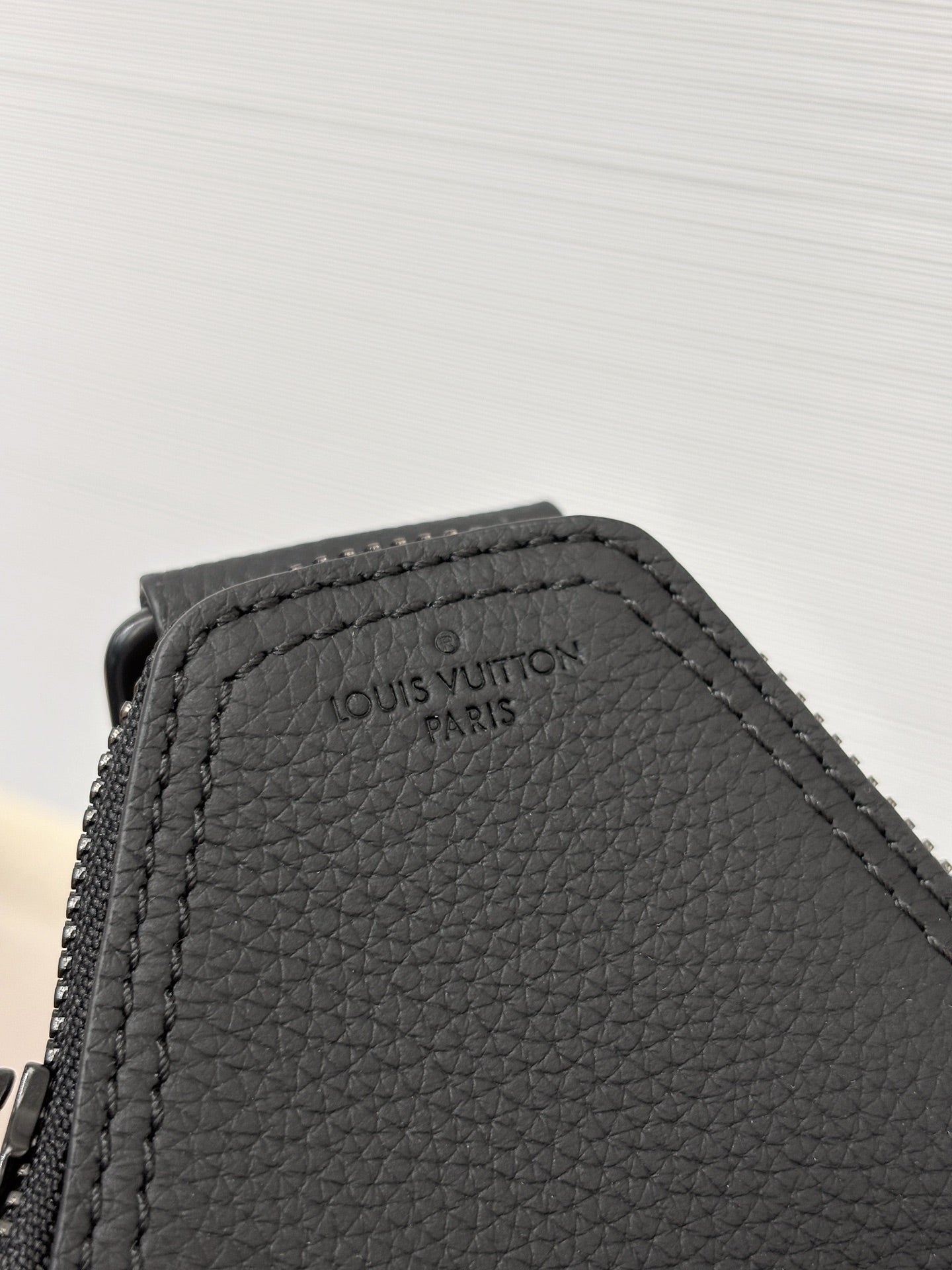 Louis Vuitton black leather panel with embossed Louis Vuitton Paris logo