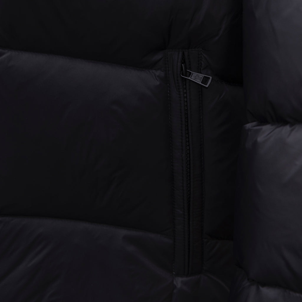 Dark puffer jacket side close-up of center front zipper
