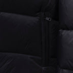 Dark puffer jacket side close-up of center front zipper