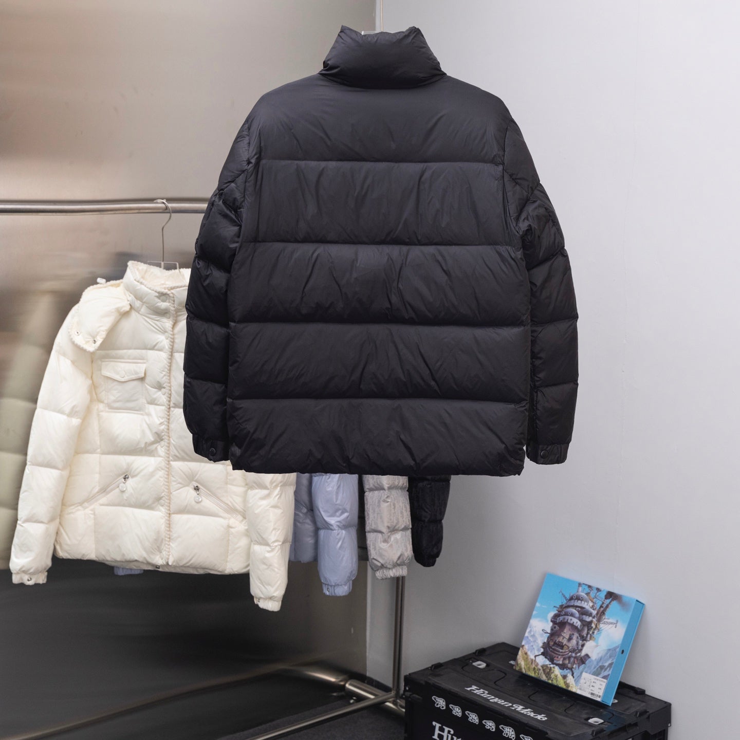 Dark long puffer jacket with stand collar and quilted horizontal baffles