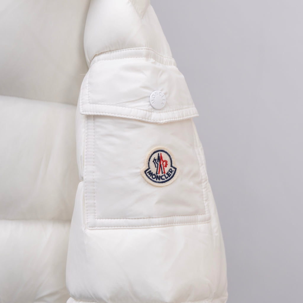 White Moncler puffer jacket sleeve with round Moncler logo patch