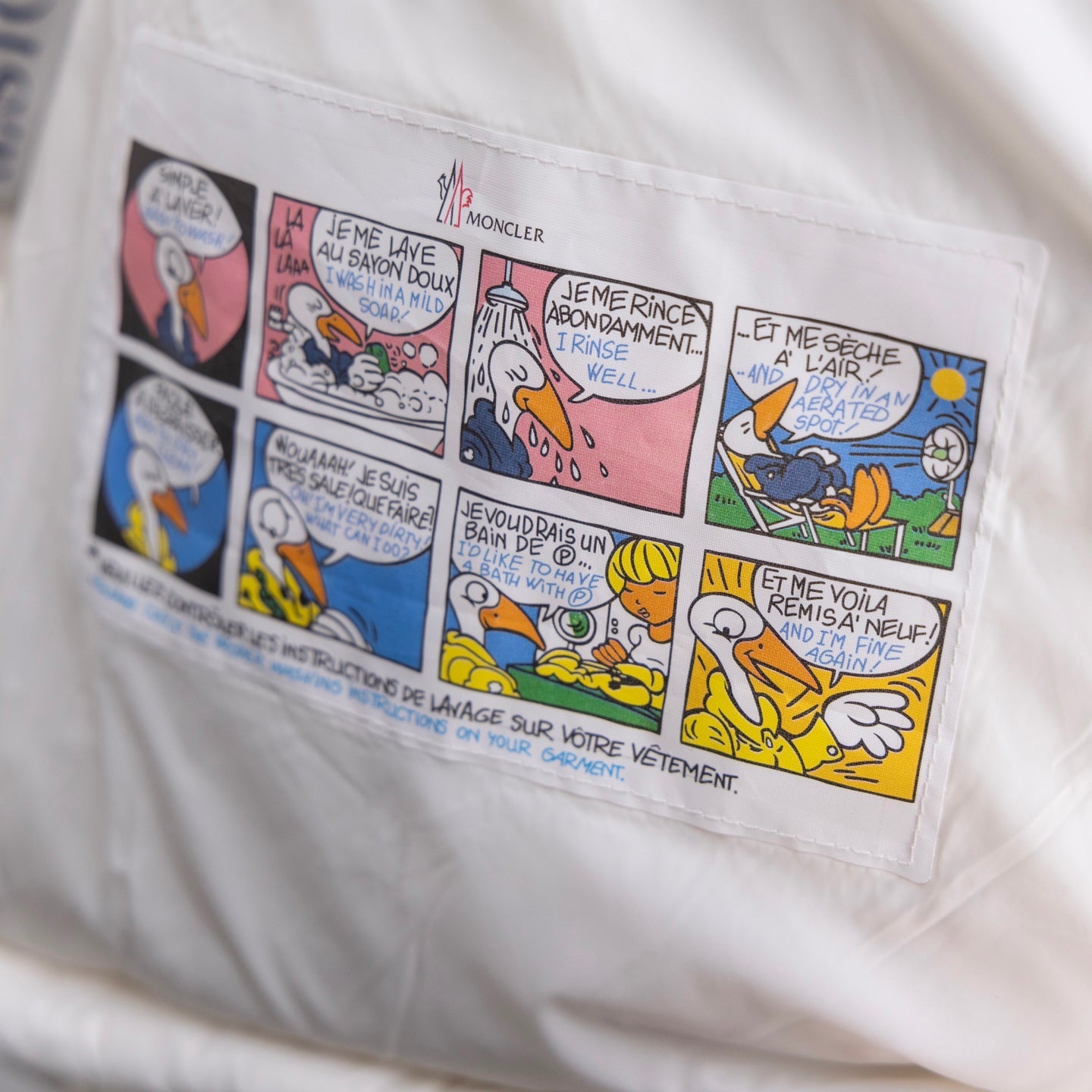 Moncler puffer jacket printed lining with colorful comic-style artwork